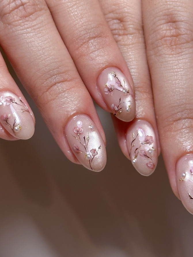 Nude acrylic nails with hand-painted sakura blossoms