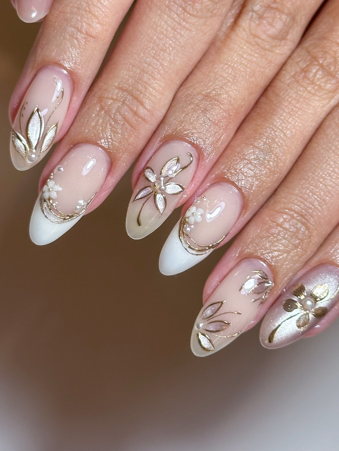 Nude acrylic nails with gold floral accents