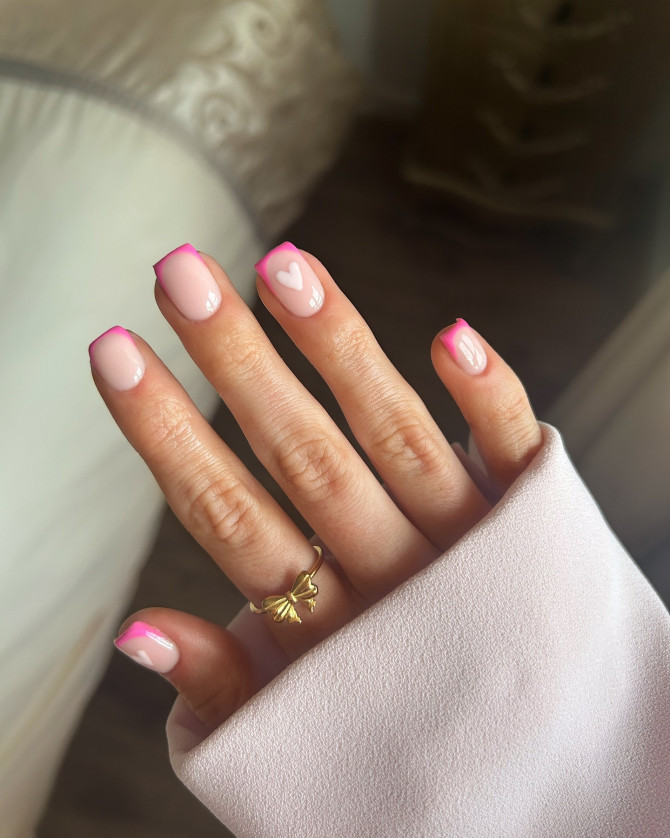 Pink French tip acrylic nails with heart accent