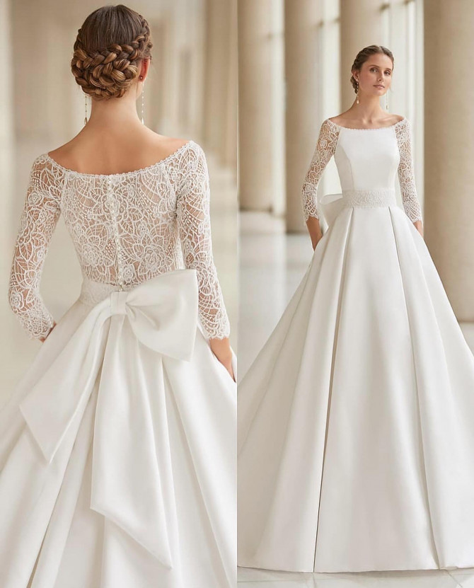  Boat-neck lace bodice with three-quarter sleeves and grand bow back — international bridal gowns classic. 