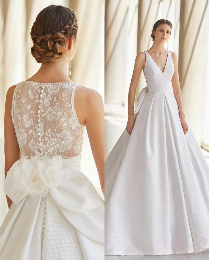  V-neck ballgown with lace illusion back and floral bow — international bridal gowns elegant.