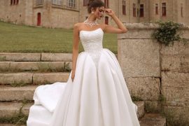 Strapless regal ballgown with dramatic full skirt photographed at a château — international bridal gowns fairytale.