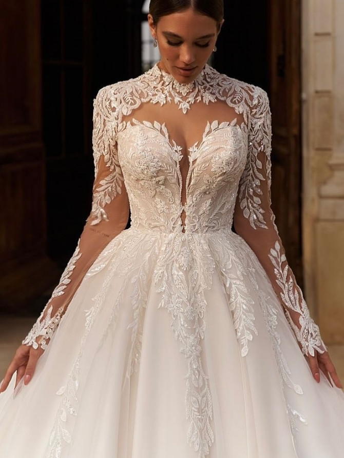High-neck illusion lace ballgown with leafy appliqués cascading onto a soft tulle skirt. “Off-shoulder floral ballgown with bishop sleeves; romantic bridal gowns mood