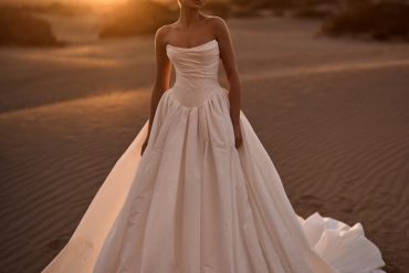 Dramatic draped taffeta ballgown at sunset; statement bridal gowns moment.
