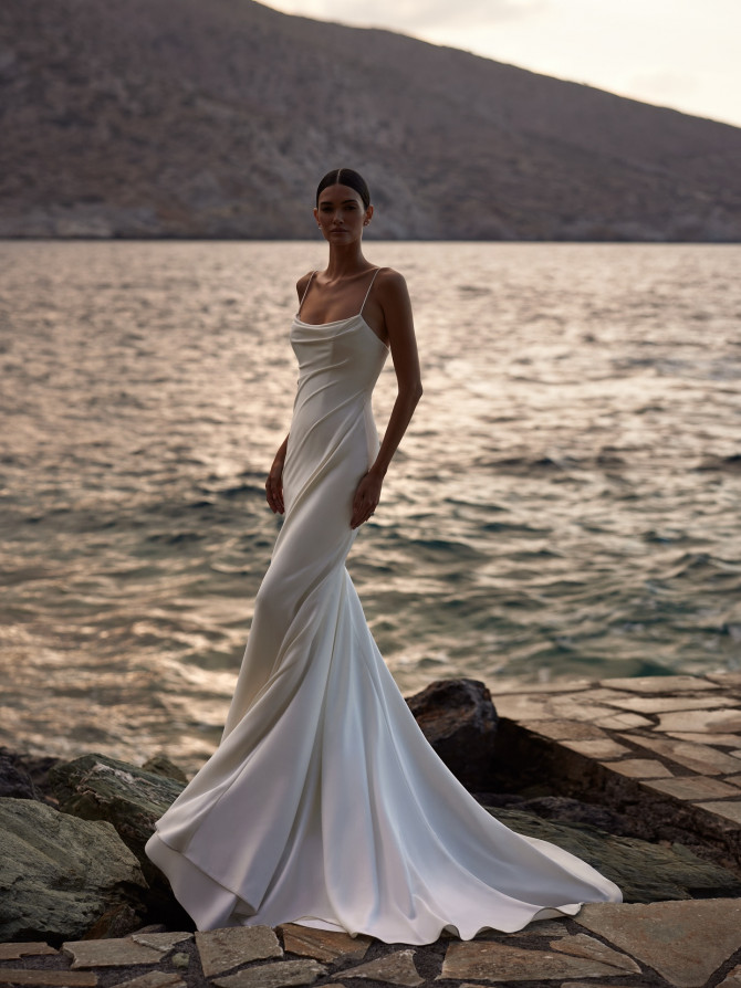 Satin cowl-neck sheath by the sea; minimal bridal gowns silhouette with slender straps