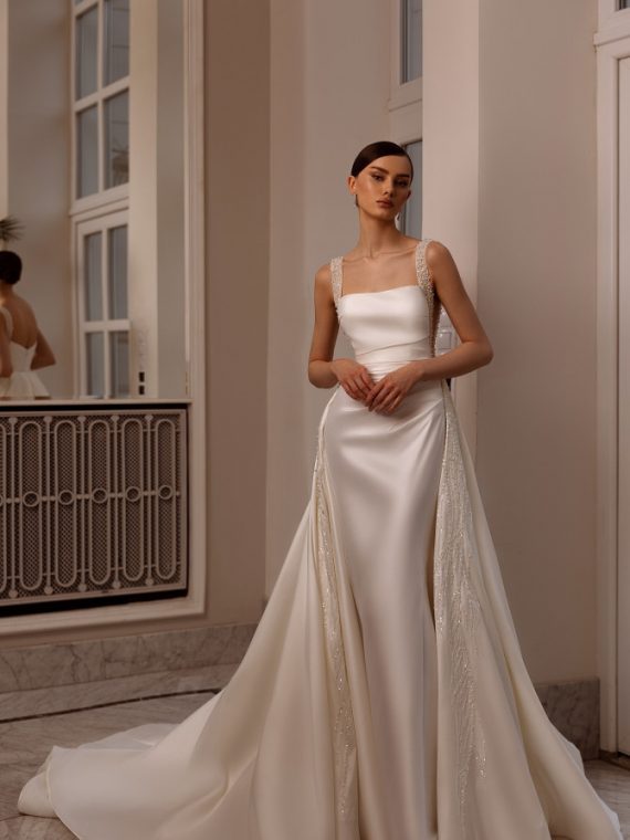 Satin square-neck sheath with beaded straps and overskirt — international bridal gowns look.