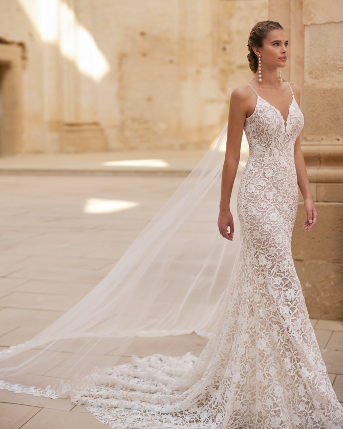 Allover lace fit-and-flare with detachable sheer cape — international bridal gowns statement.