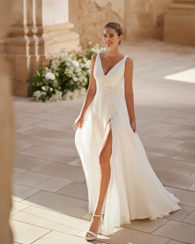 Pleated wrap chiffon gown with front slit — international bridal gowns light and airy.