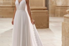 Spaghetti-strap chiffon wedding dress with lace-edged train — international bridal gowns.