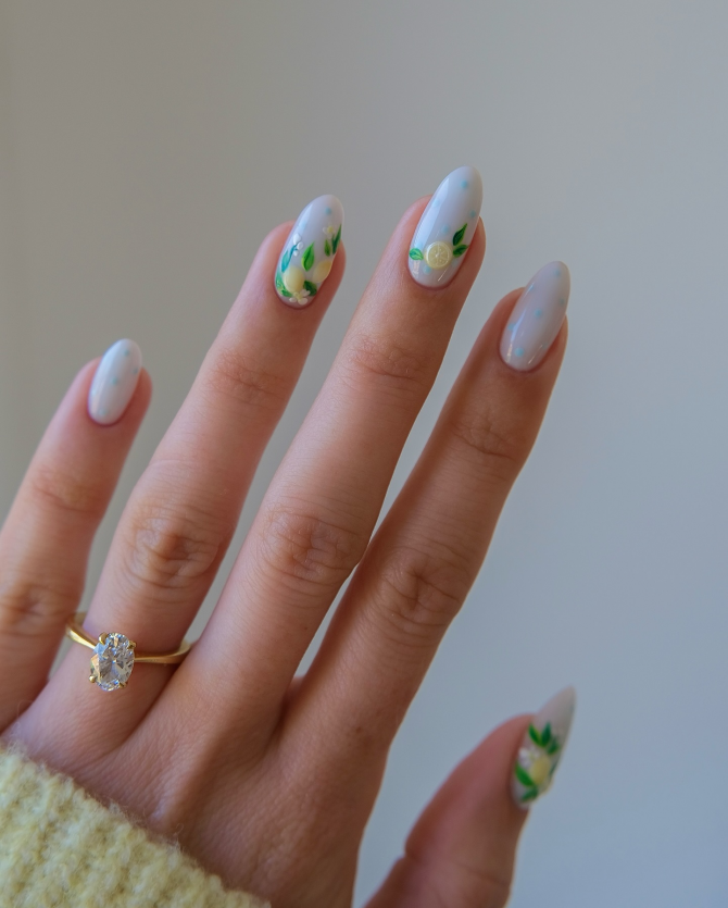 Pastel blue almond nails with lemon fruit and green leaves, refreshing summer manicure