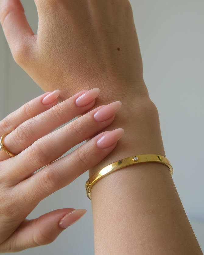Nude-pink oval manicure with glossy finish"